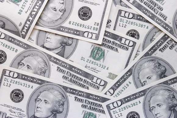 U.S. ten dollar bills scattered.