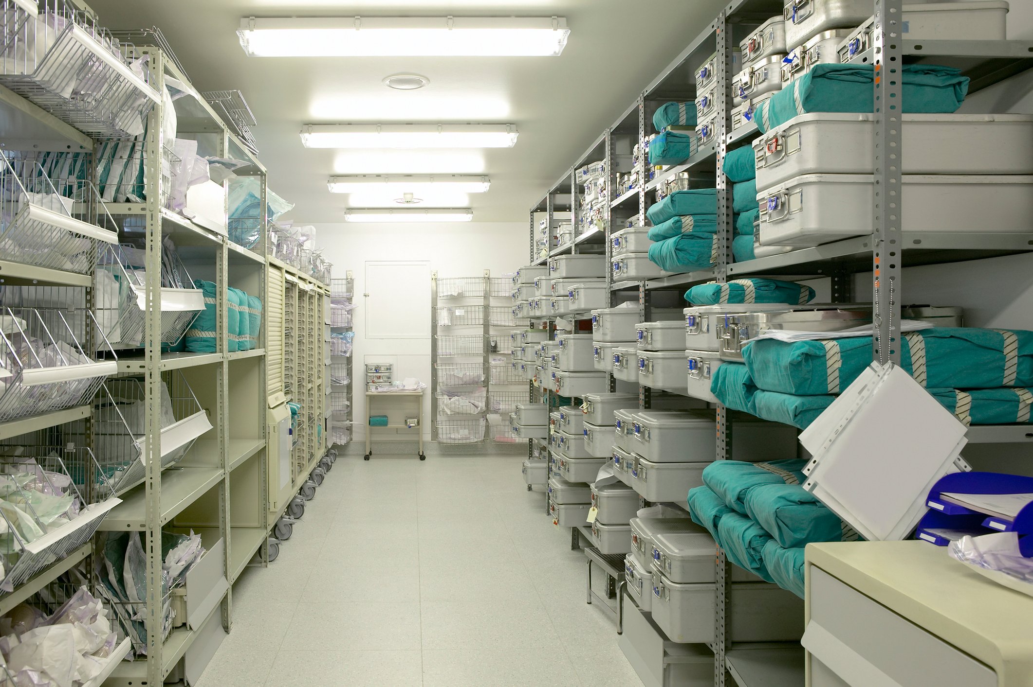 A storeroom of medical supplies in bins stacked floor to ceiling.