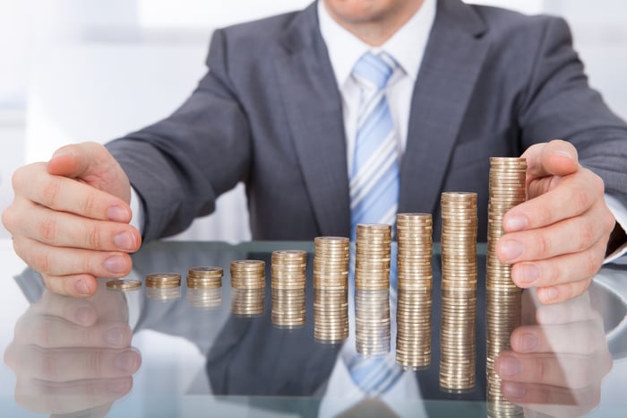 Man with stacks of coins in front of him