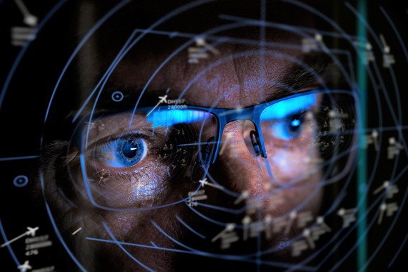 Close-up of person looking into a radar screen.