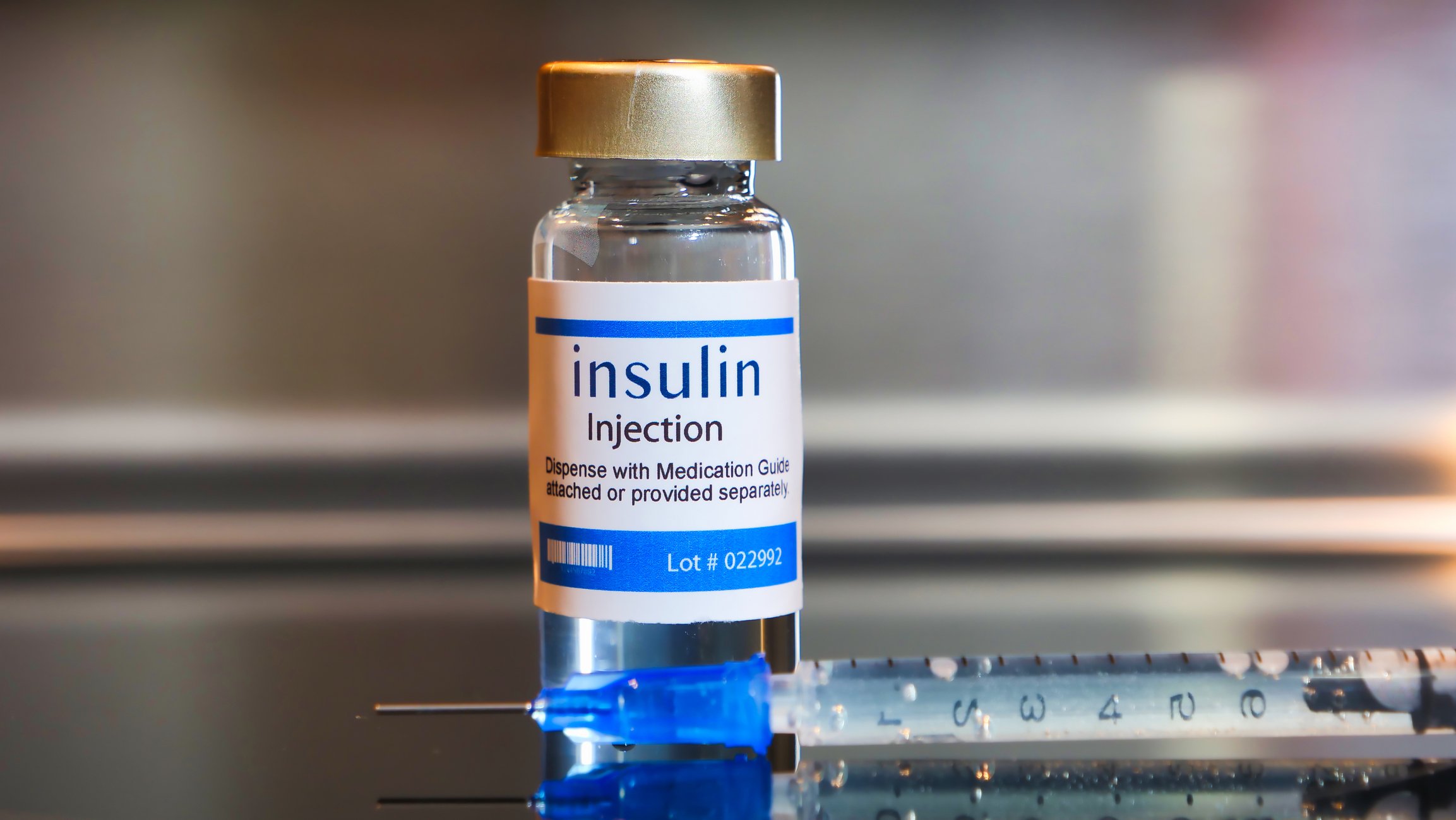 A vial of insulin and a syringe.