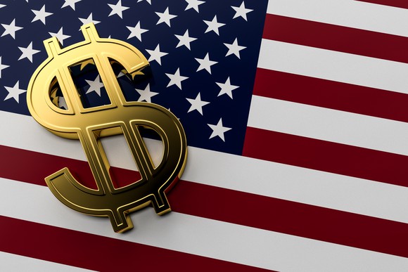 A golden dollar sign on an American flag.