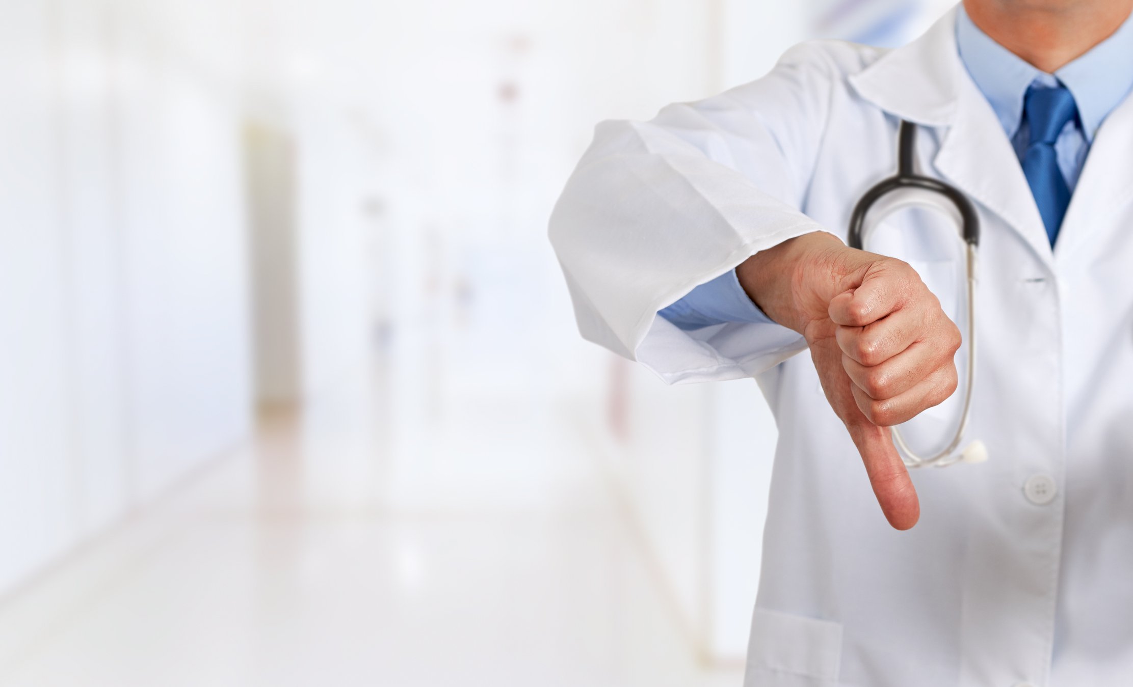 Doctor giving a thumbs down.