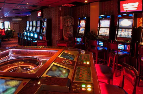 Empty roulette table and slot machines