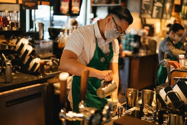 Starbucks barista pouring a coffee