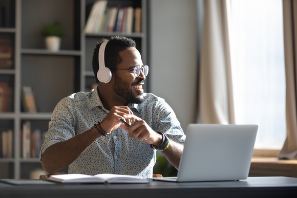 Man listening to podcast through his headphones.