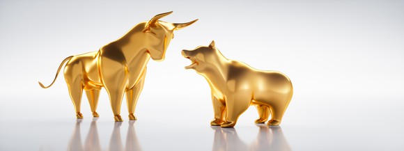 Golden bull and bear figurines facing each other. 