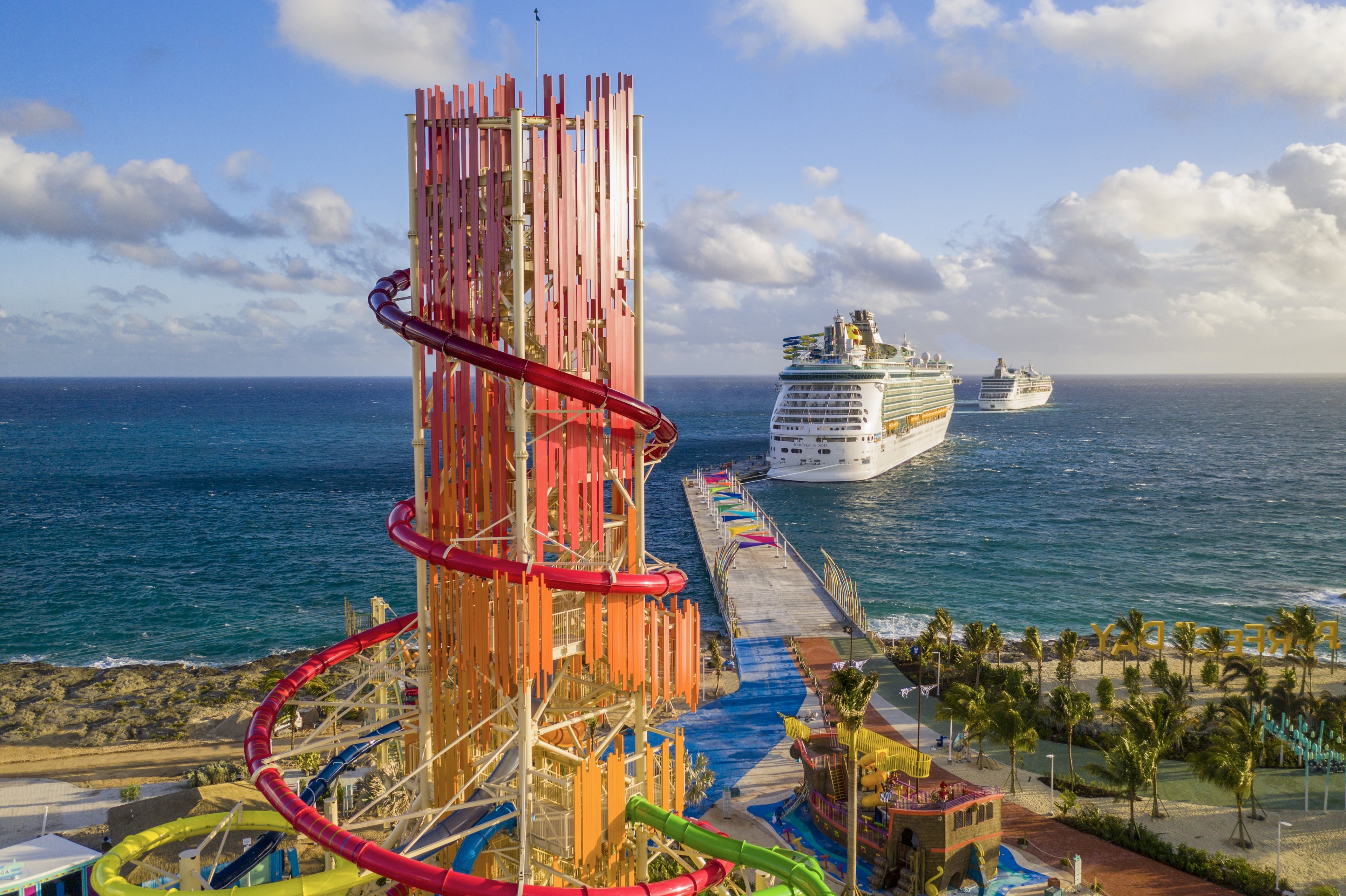 The Mariner of the Seas docked at CocoCay, with a waterpark attraction in the foreground.