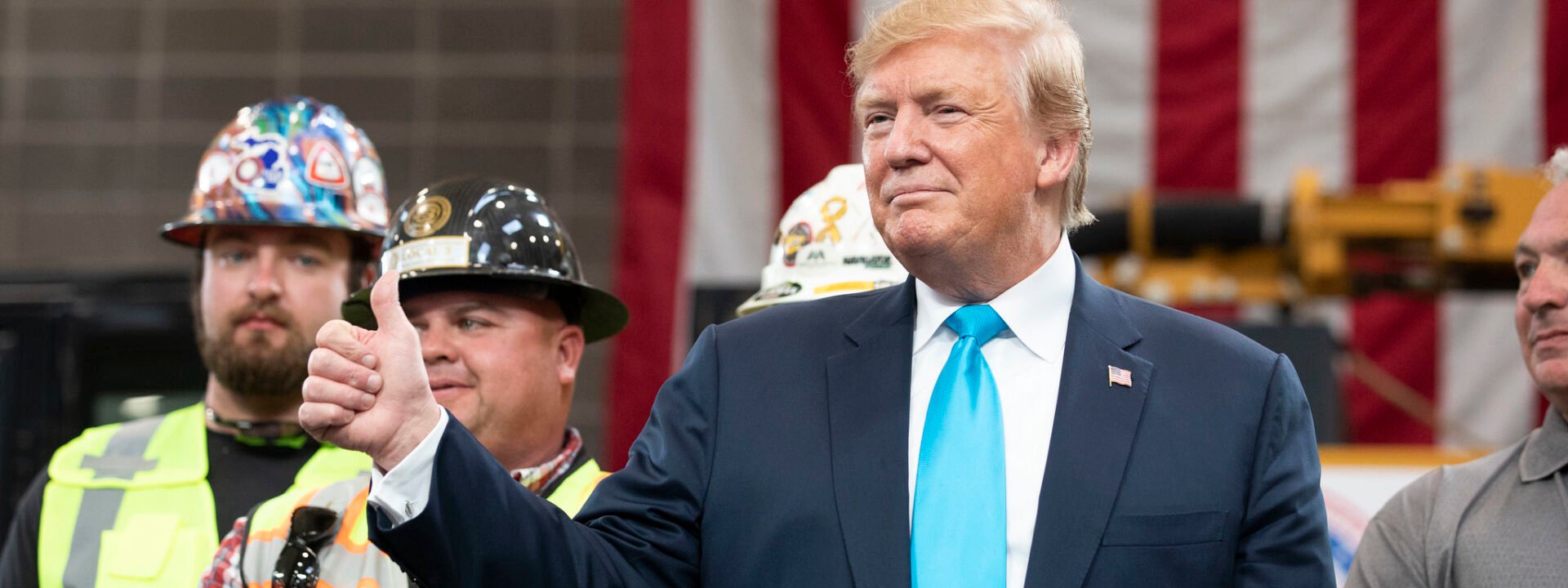 President Trump gives a thumbs-up at an event with construction workers