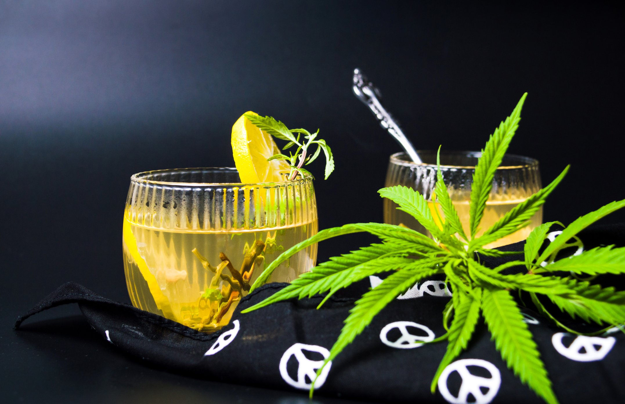 Cannabis tea with marijuana leaves and lemon