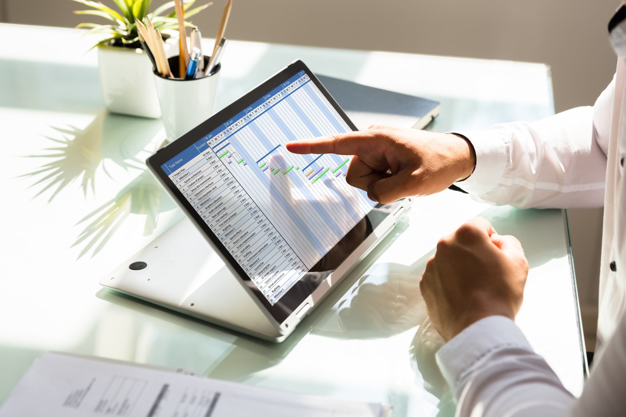 A person pointing to a tablet screen.
