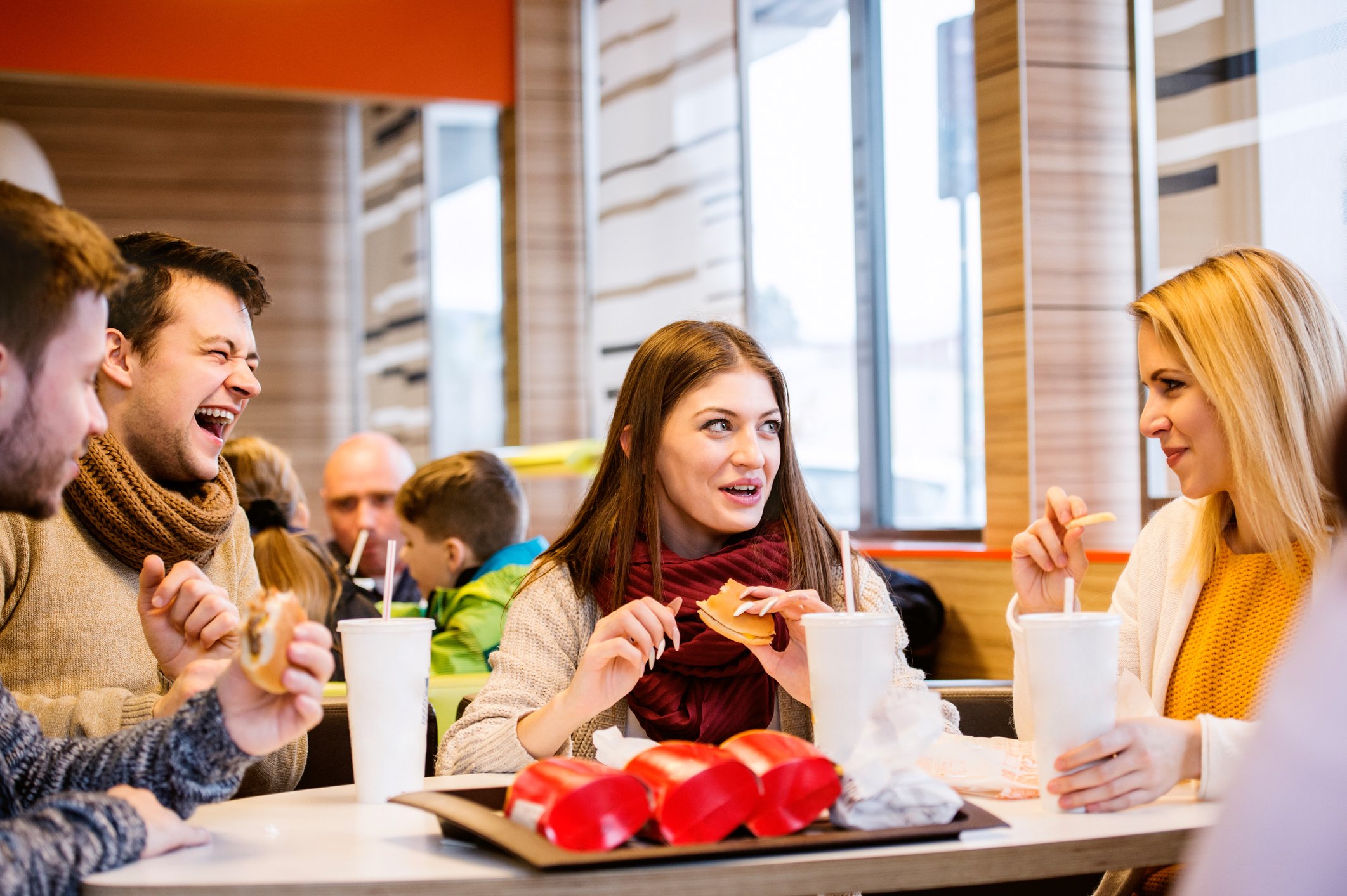 Young adults sharing a fast-food meal.