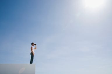 looking through binoculars