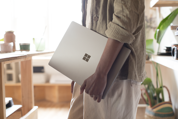 Person carrying a Surface Laptop. 