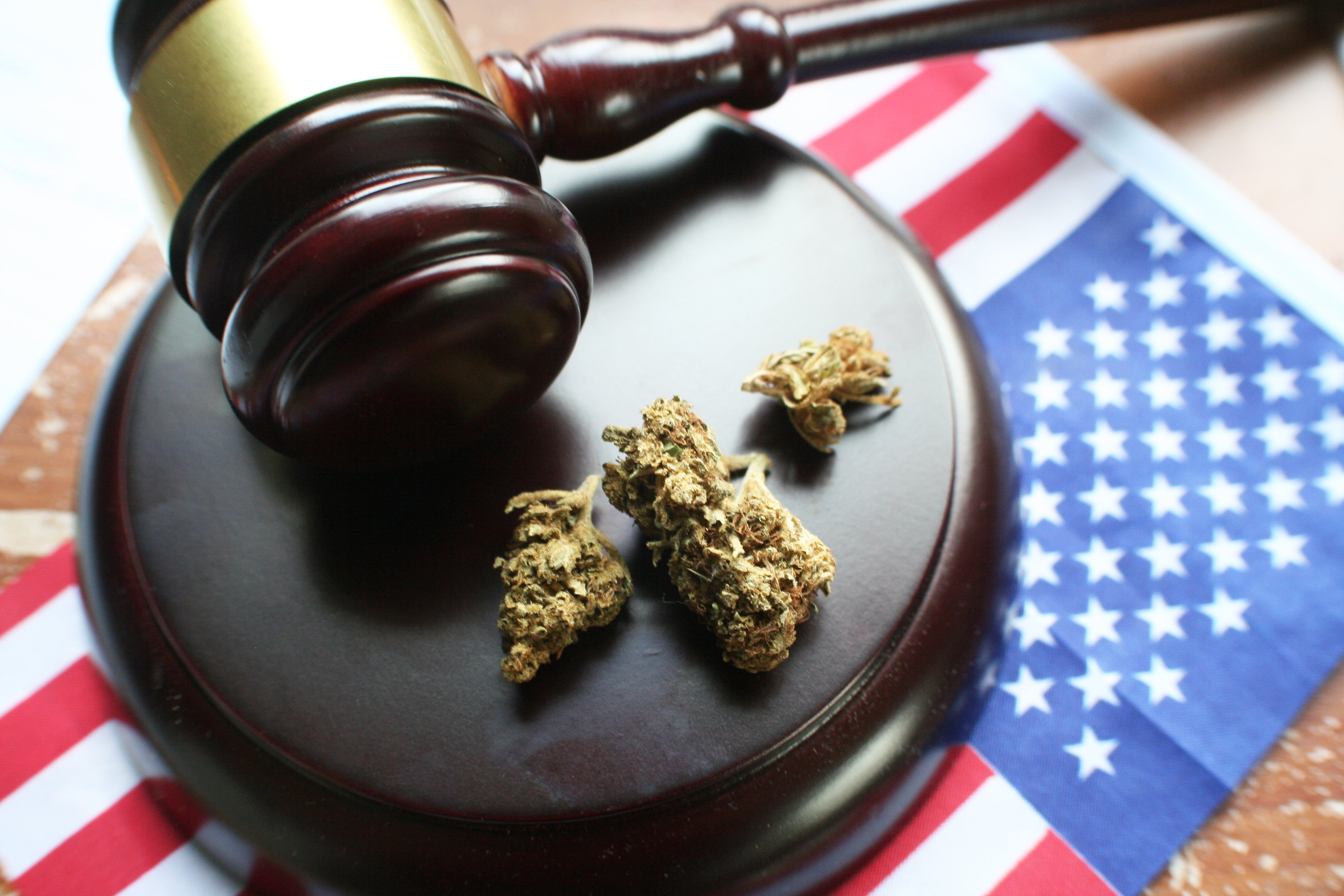 Gavel with marijuana atop an American flag.