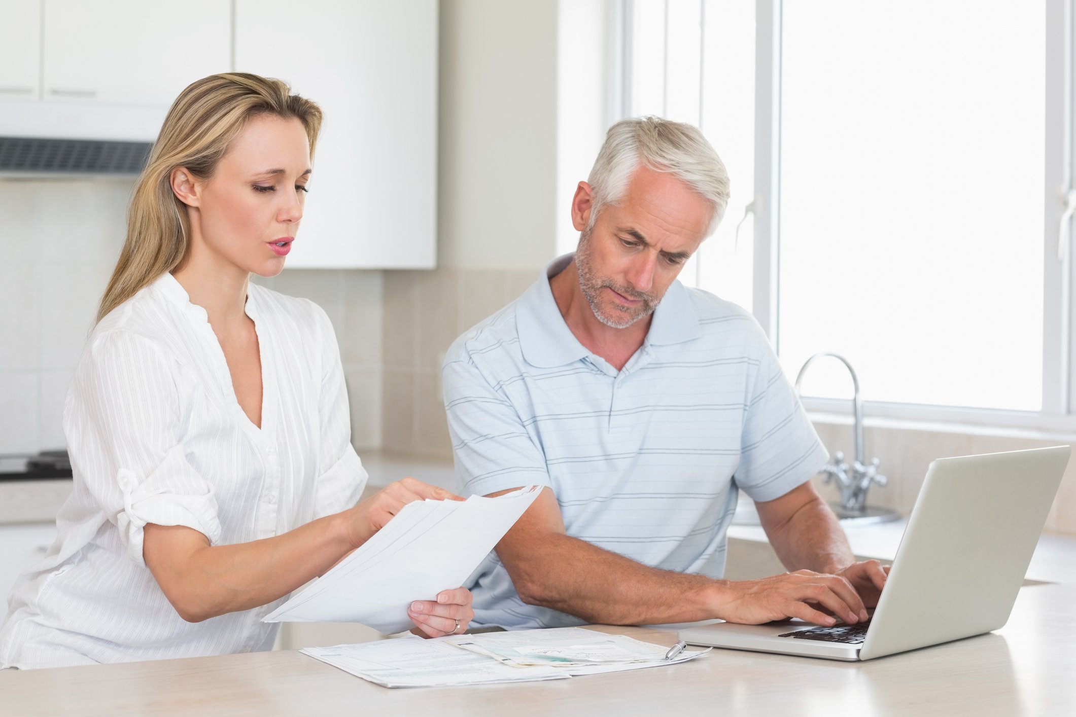 Couple reviewing finances with their laptop at home. 