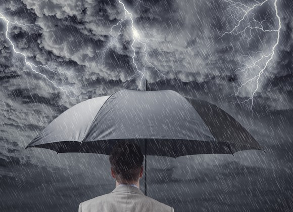 Man holding an umbrella in a thunderstorm