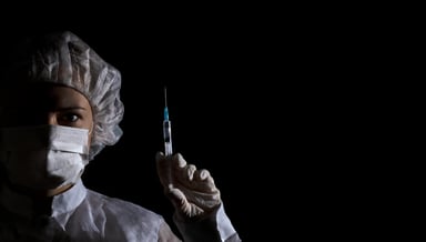 Healthcare professional holding vaccine