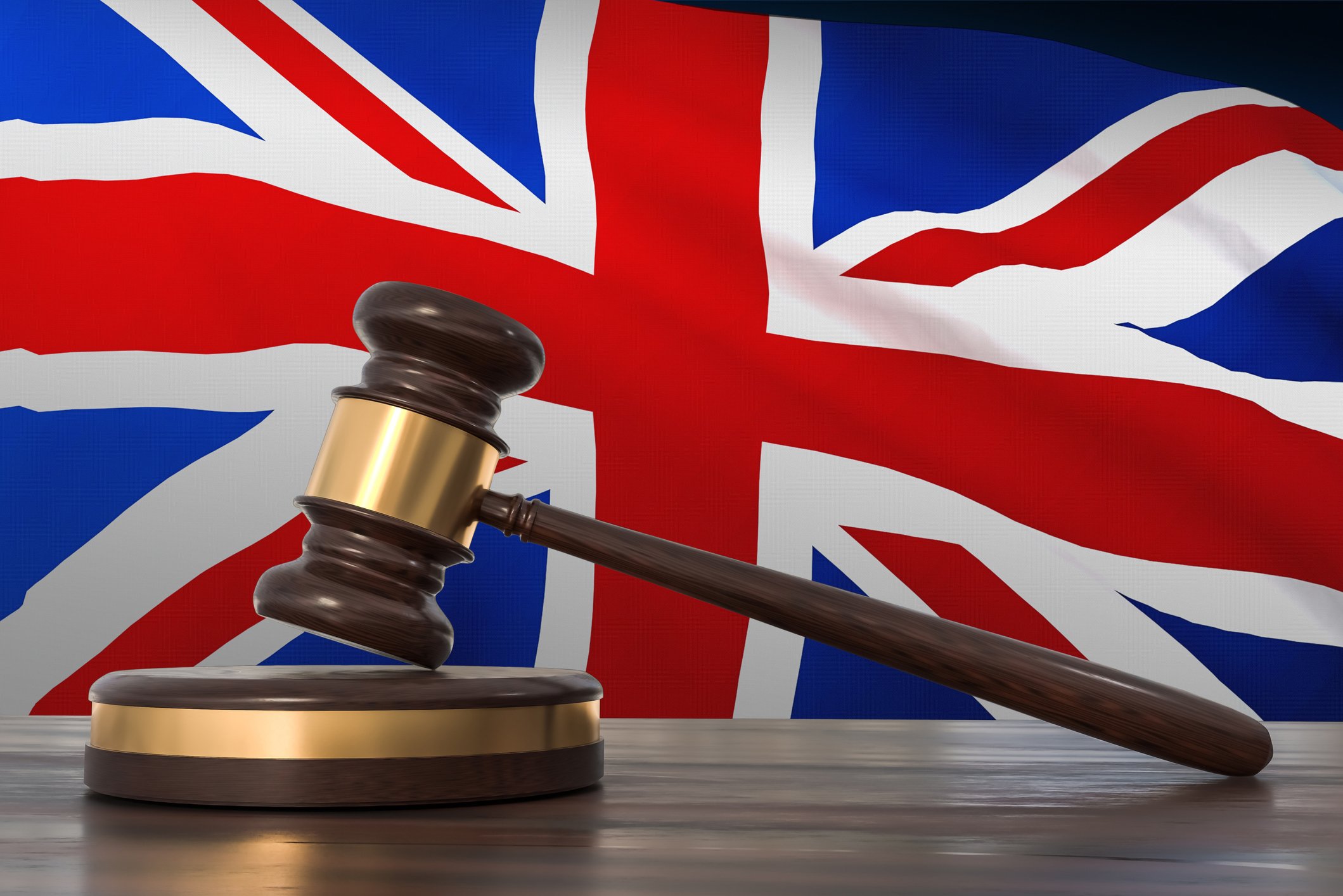 Gavel and block against a British flag in background