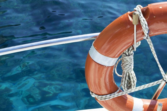 A life preserver tied to boat in the open water.