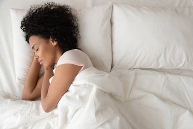Young Woman Sleeping Peacefully in Bed