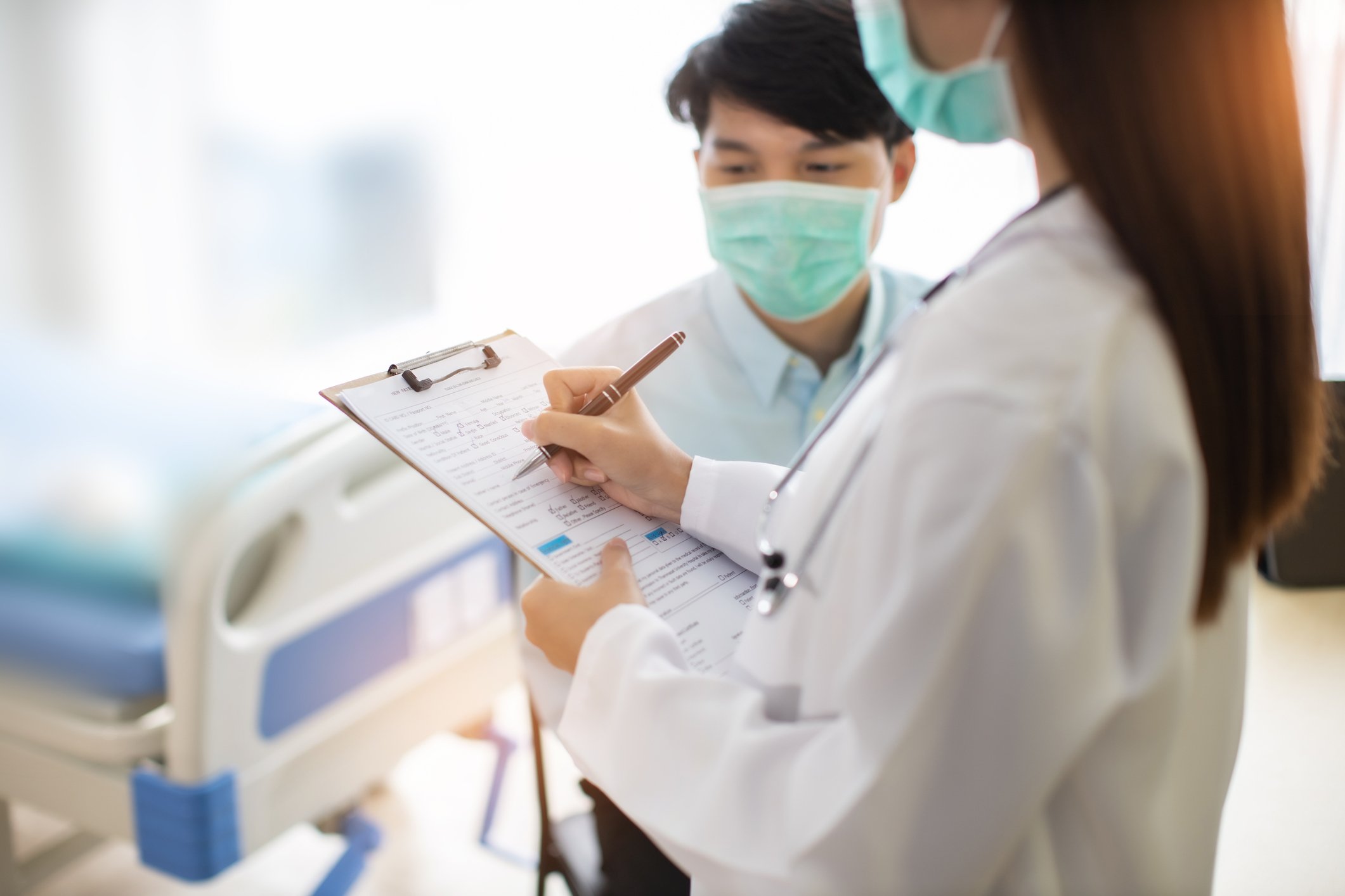 Physician with COVID-19 patient wearing mask