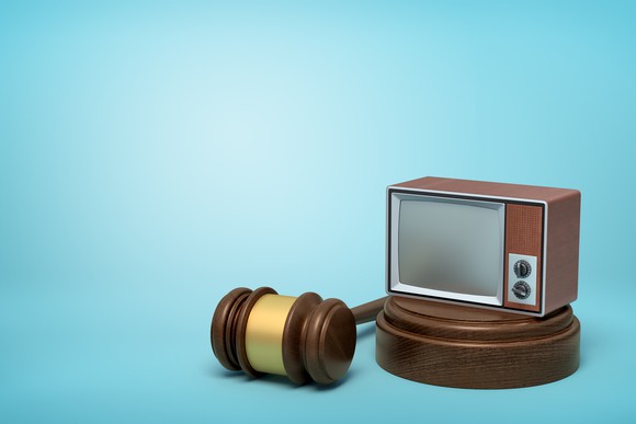 TV on a stand next to a gavel.