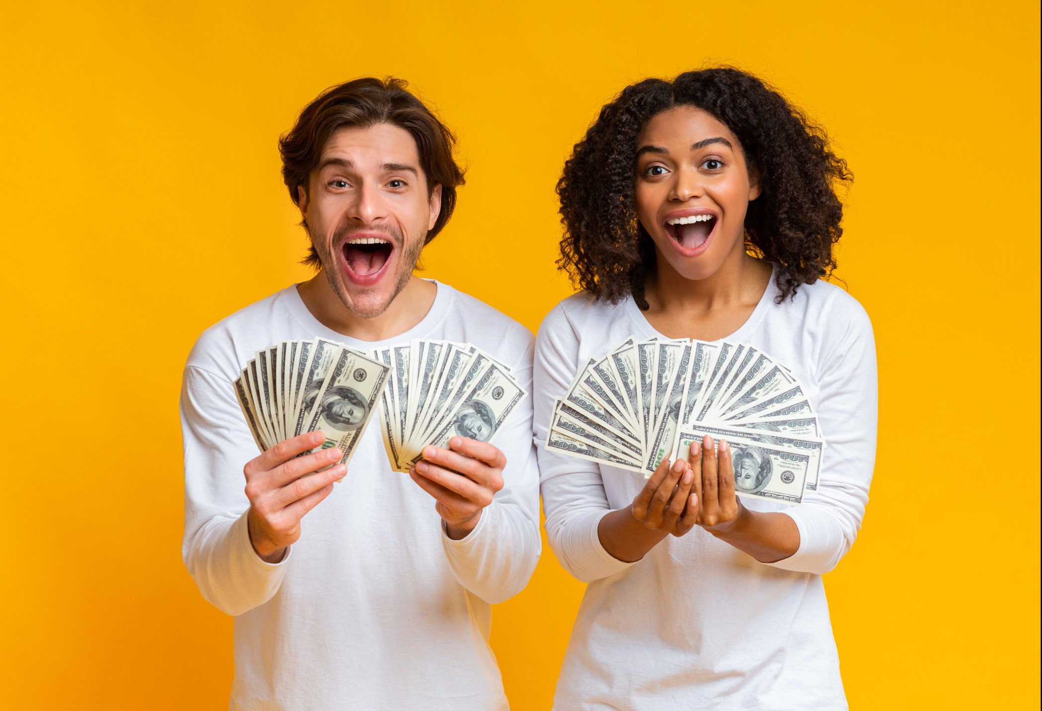Getty Money Held by Young Man and Woman