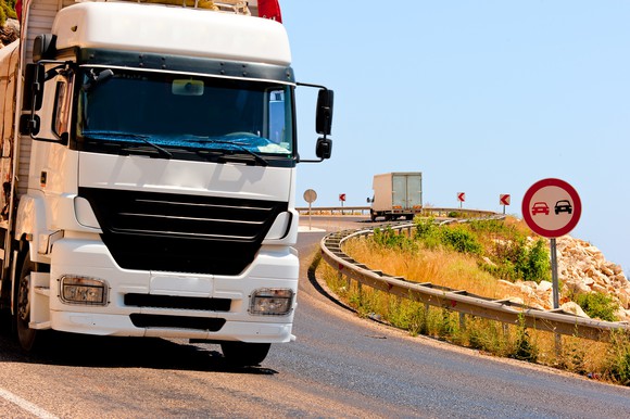 Tractor trailer headed downhill on a windy road