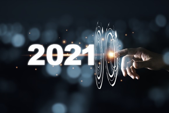 A person is touching a screen of sorts where it says 2021.