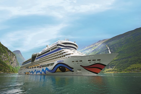 The brightly decorated hull of Carnival's AIDAblu ship at sail.