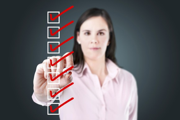 Woman checking a checklist in front of her. 