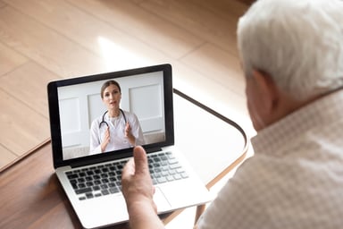 Man looking a doctor on laptop