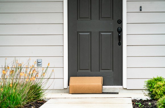 A package sits by a front door.