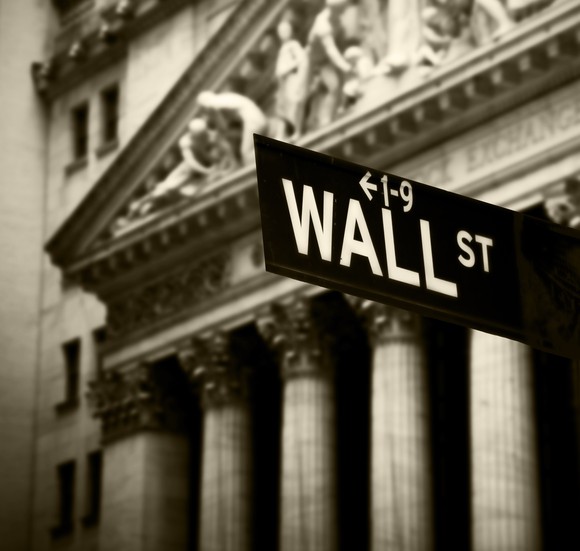 Wall Street sign in front of New York Stock Exchange.