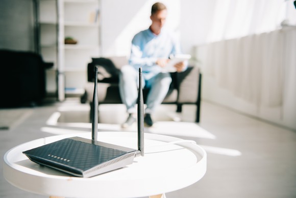 Man sitting near a wireless router