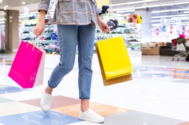 Woman holding shopping bags in a mall