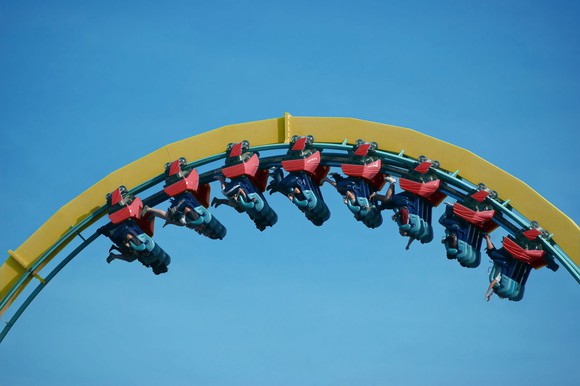 Roller coaster with people upside down.