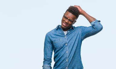 Young man scratching his head