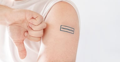 Thumb down next to arm with vaccinated