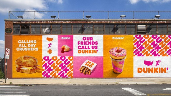 dunkin' donuts, coffee and food displayed with brand on side of building