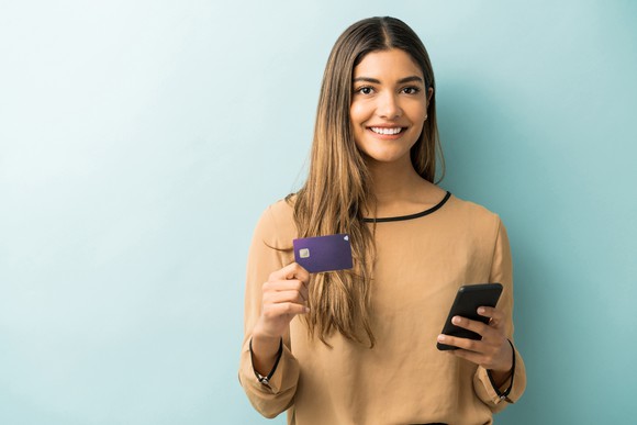 Woman holding a credit card.