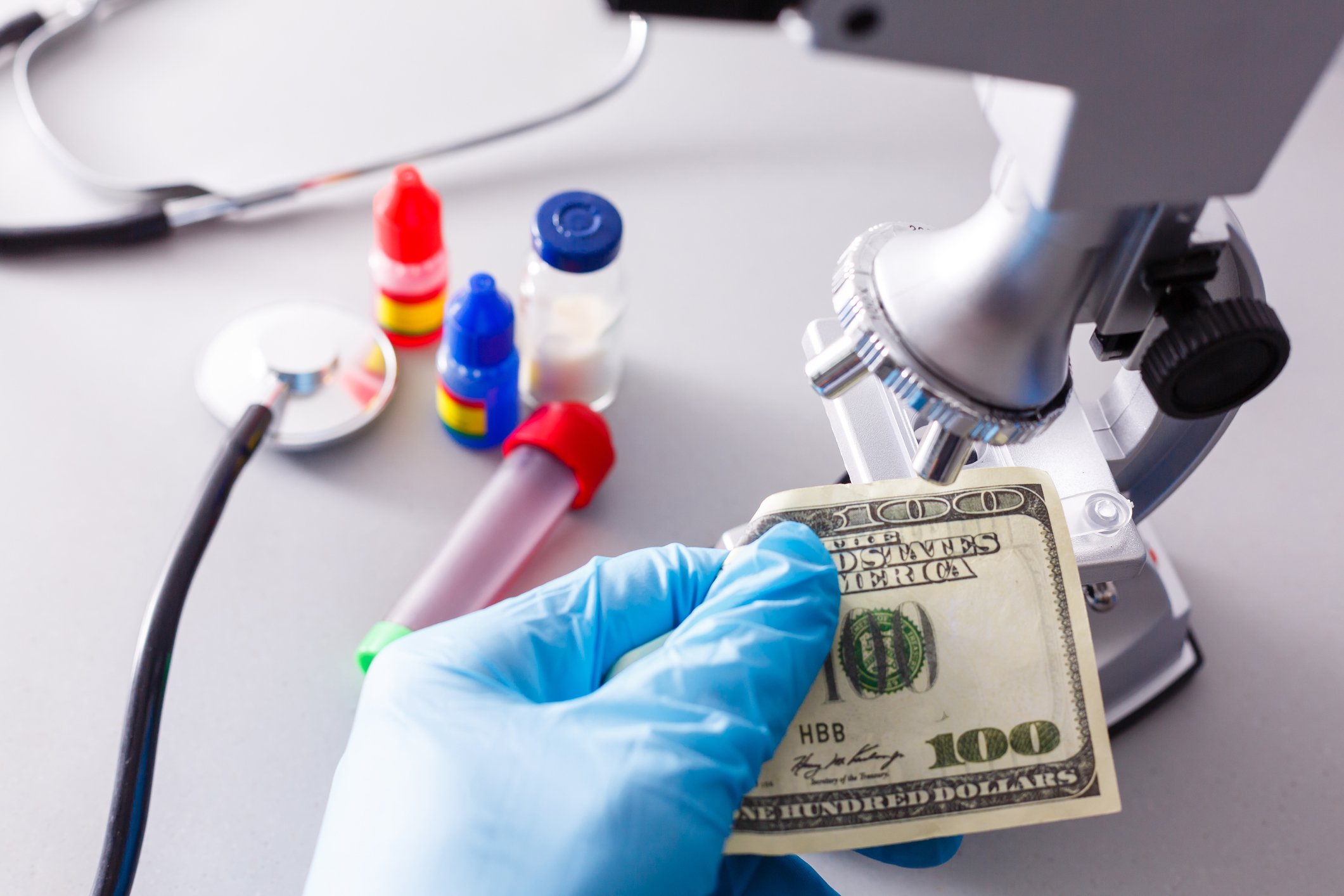 A $100 bill is examined under a microscope.