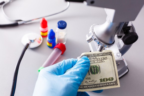 A $100 bill is examined under a microscope.