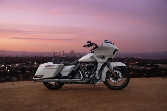 White motorcycle in front of Los Angeles skyline