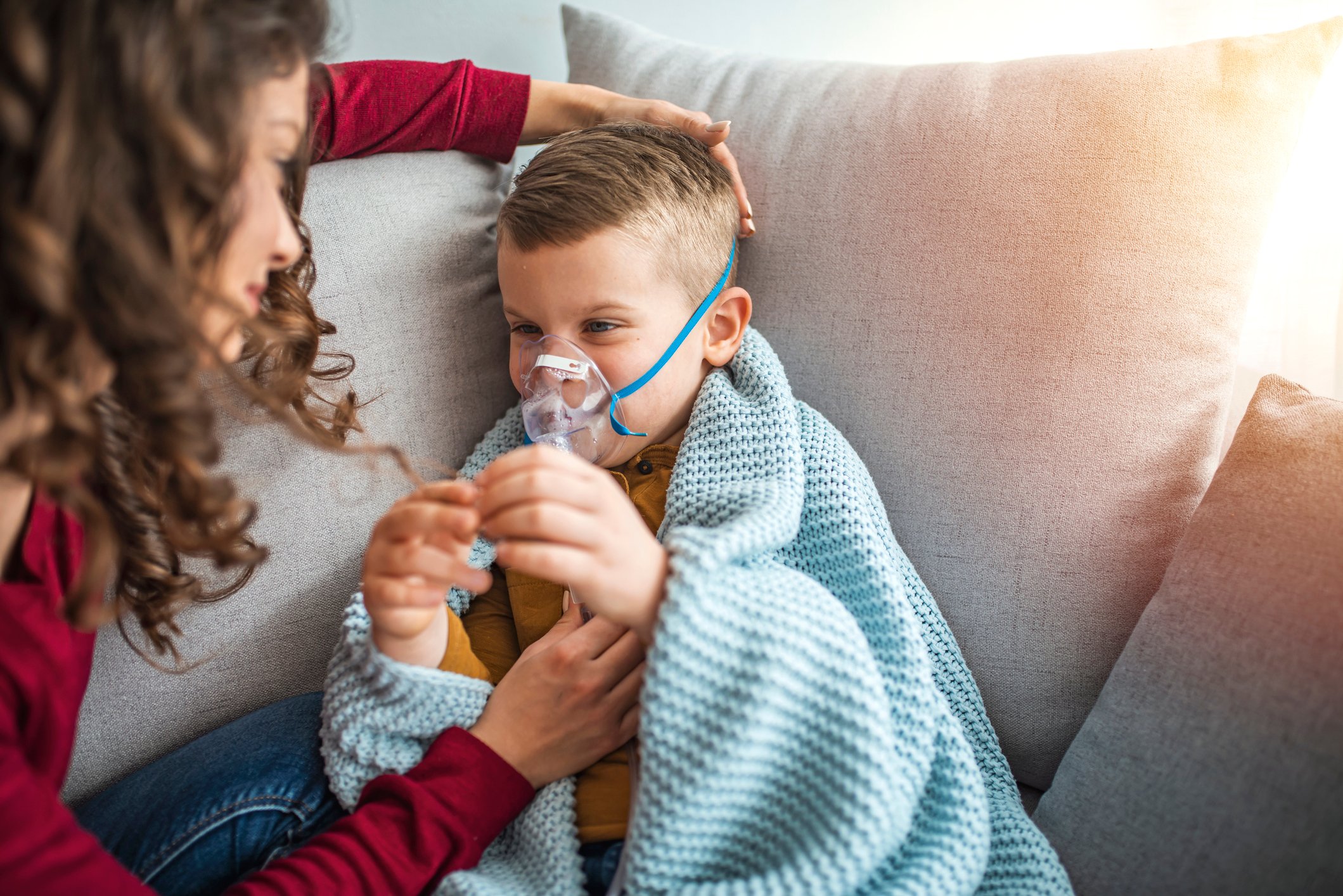 A child with cystic fibrosis gets an inhaler treatment.