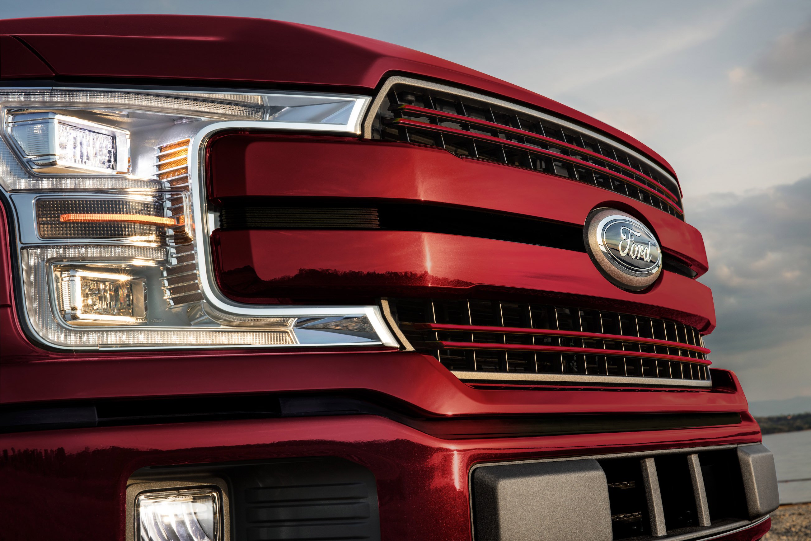 The front end of a red Ford F-150 pickup truck. 