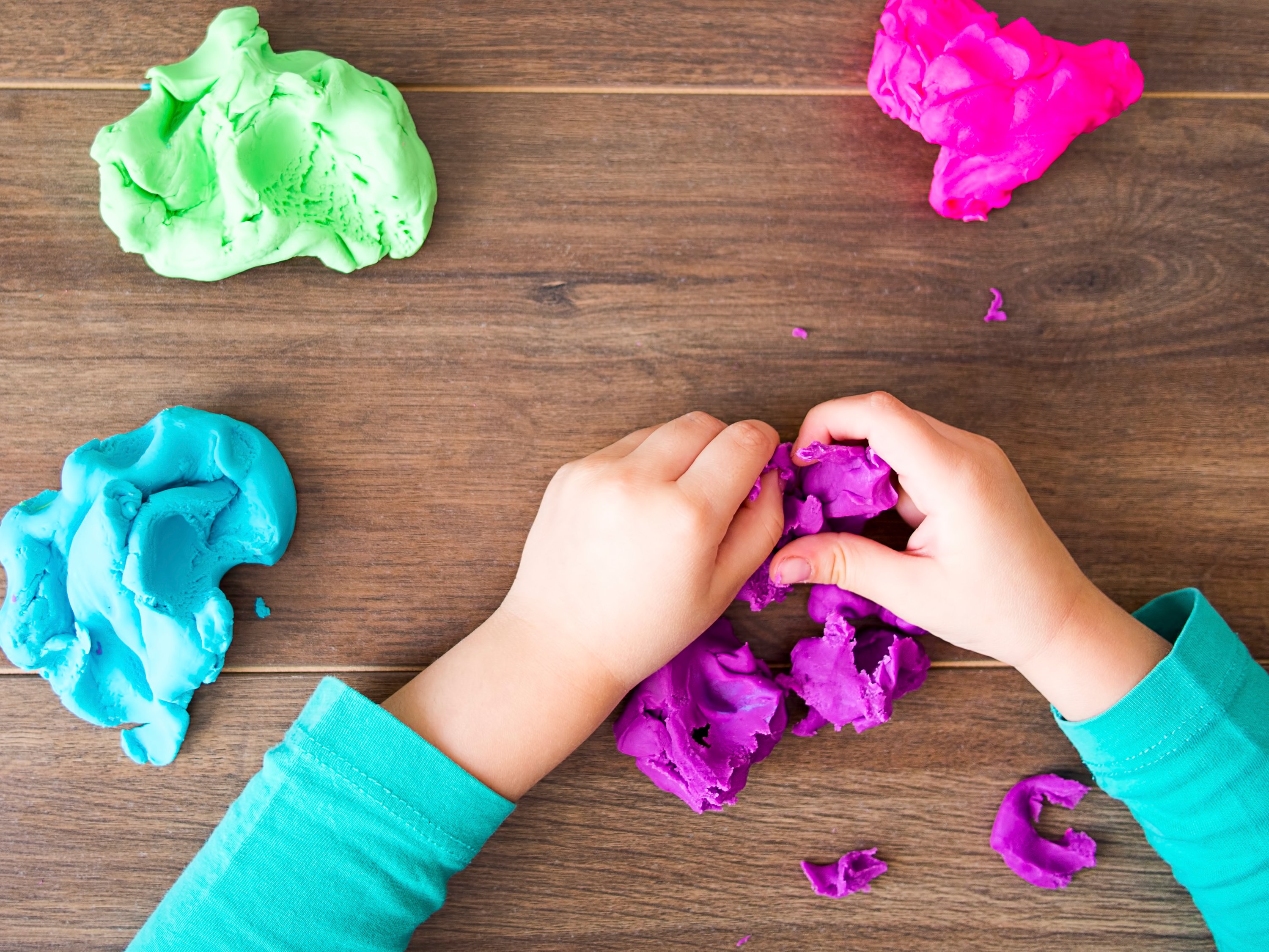A child's hands working with play doh.