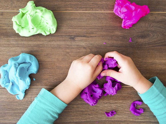 A child's hands working with play doh.