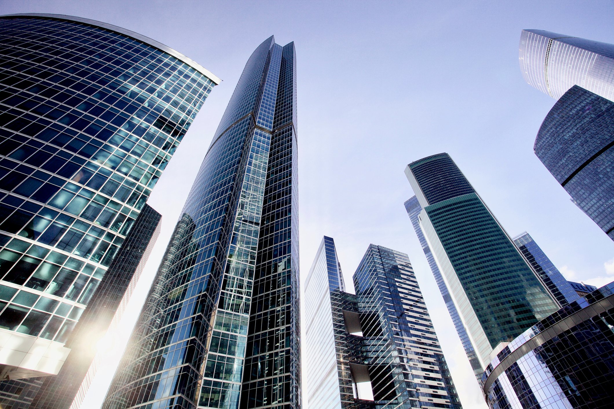 Multiple skyscrapers framed against the sky from a ground perspective